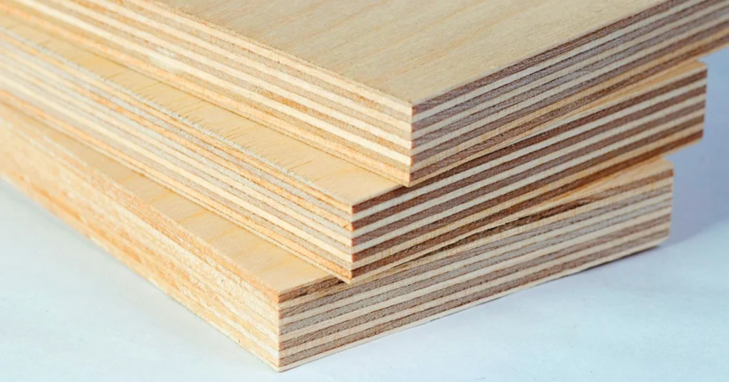 Close-up of plywood boards stacked together showing layered construction for bathroom cabinets