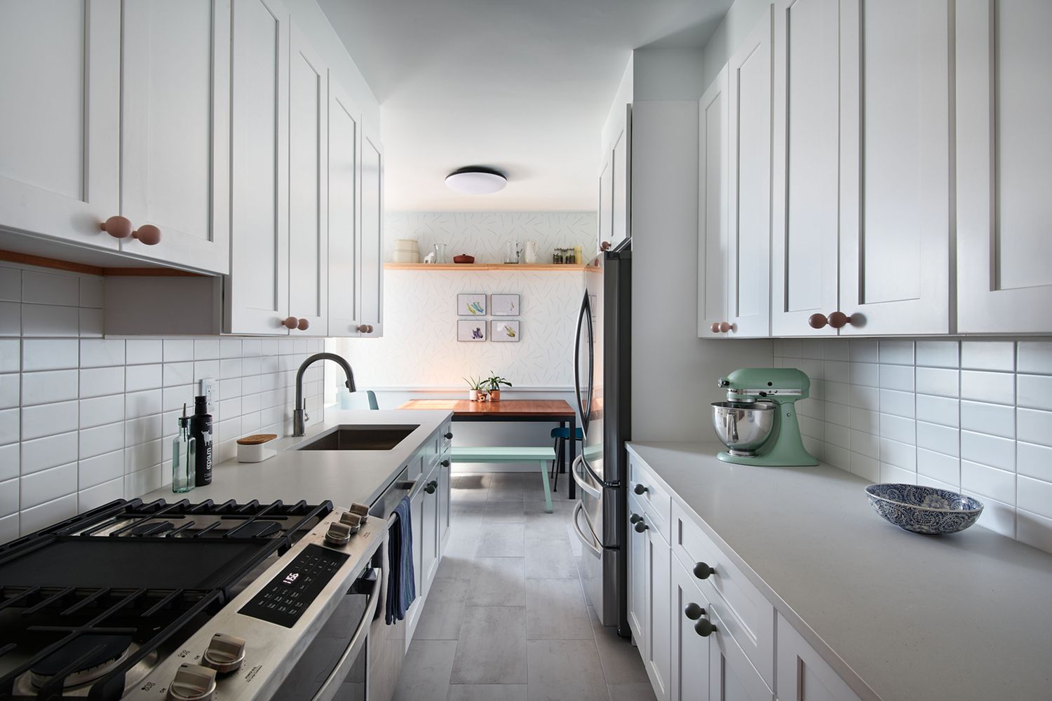 Bright white shaker-style galley kitchen cabinets with subway tile backsplash, stainless steel appliances, and modern compact layout in Mississauga home