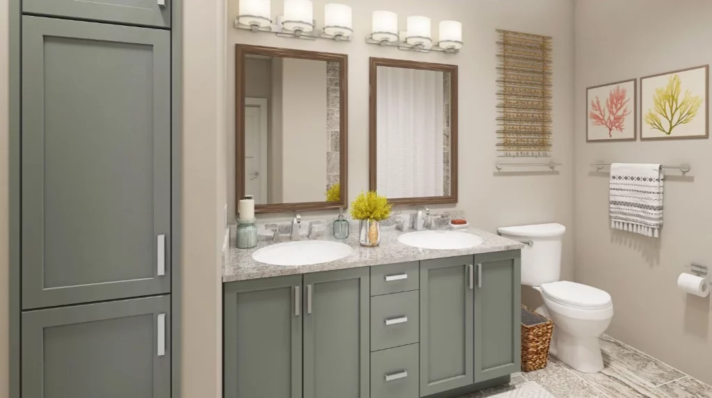Bathroom with gray-green cabinets, double sinks, granite countertop, and modern lighting above mirrors.