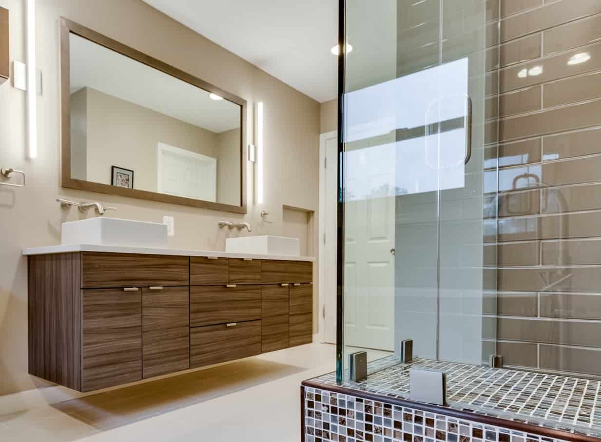 Modern bathroom with floating vanity in wood finish, showcasing Minimalist Bathroom Cabinets design with double sinks and large mirror
