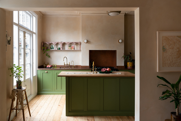 Stylish kitchen with earthy green RTA Cabinet Colors on island and base cabinets, paired with natural wood countertop and flooring