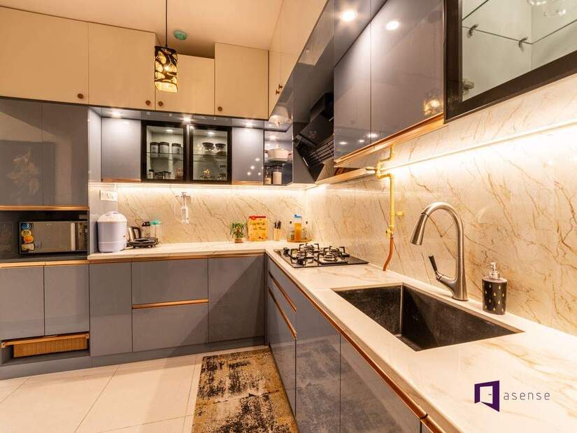 Modern RTA cabinets in Canada with sleek grey flat-panel design, marble backsplash, and under-cabinet lighting for a stylish e-commerce kitchen solution