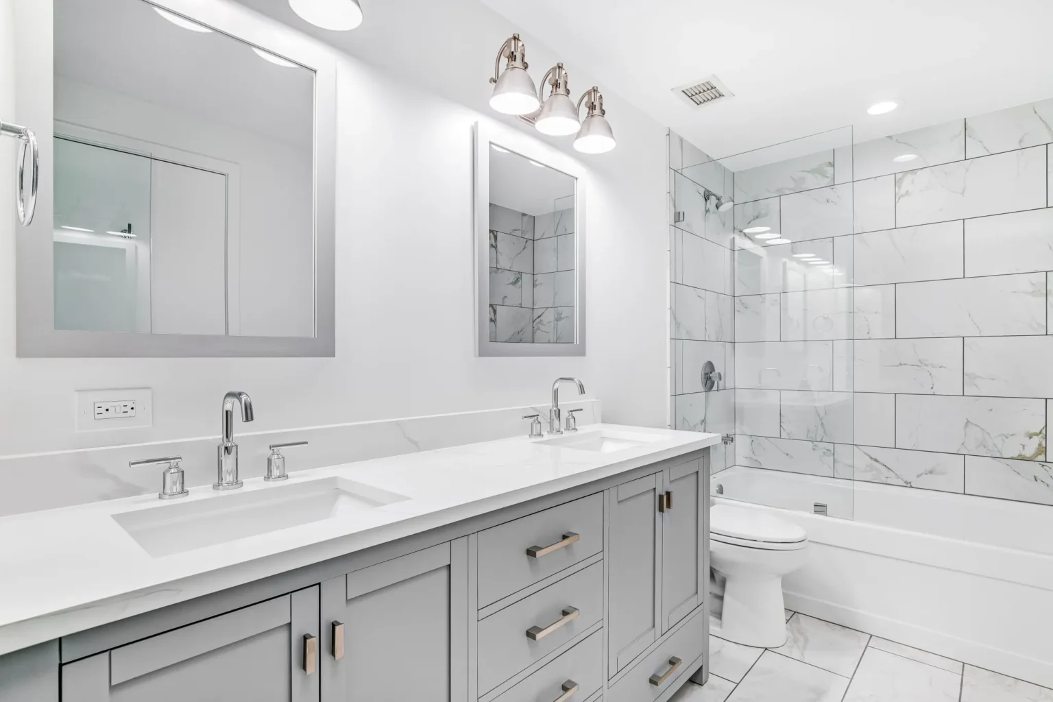 Modern white bathroom with gray double vanity cabinets – how to keep bathroom cabinets from mold in humid spaces