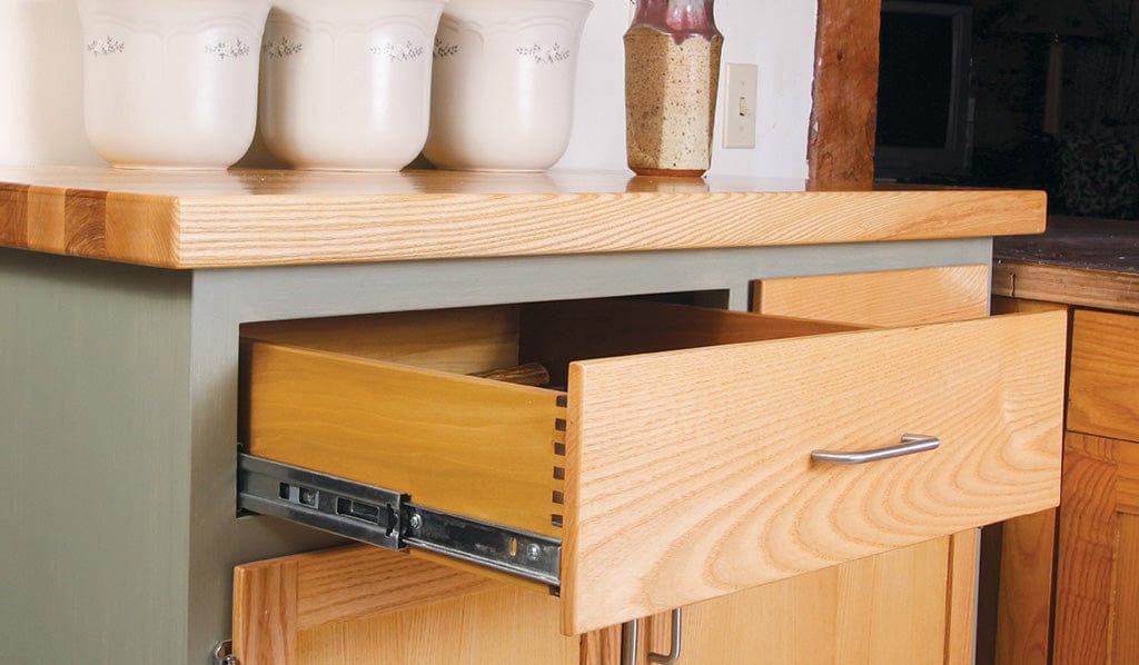 Ball-Bearing Drawer Slides installed on a wooden kitchen cabinet