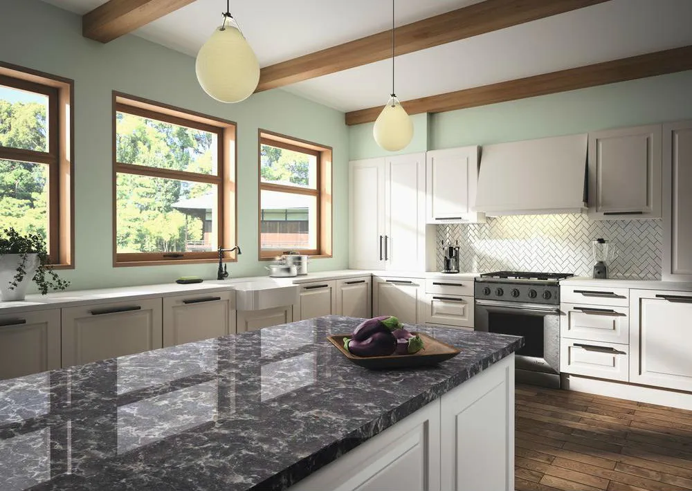 Kitchen with white engineered wood cabinets and artificial stone countertops featuring a marble-look island