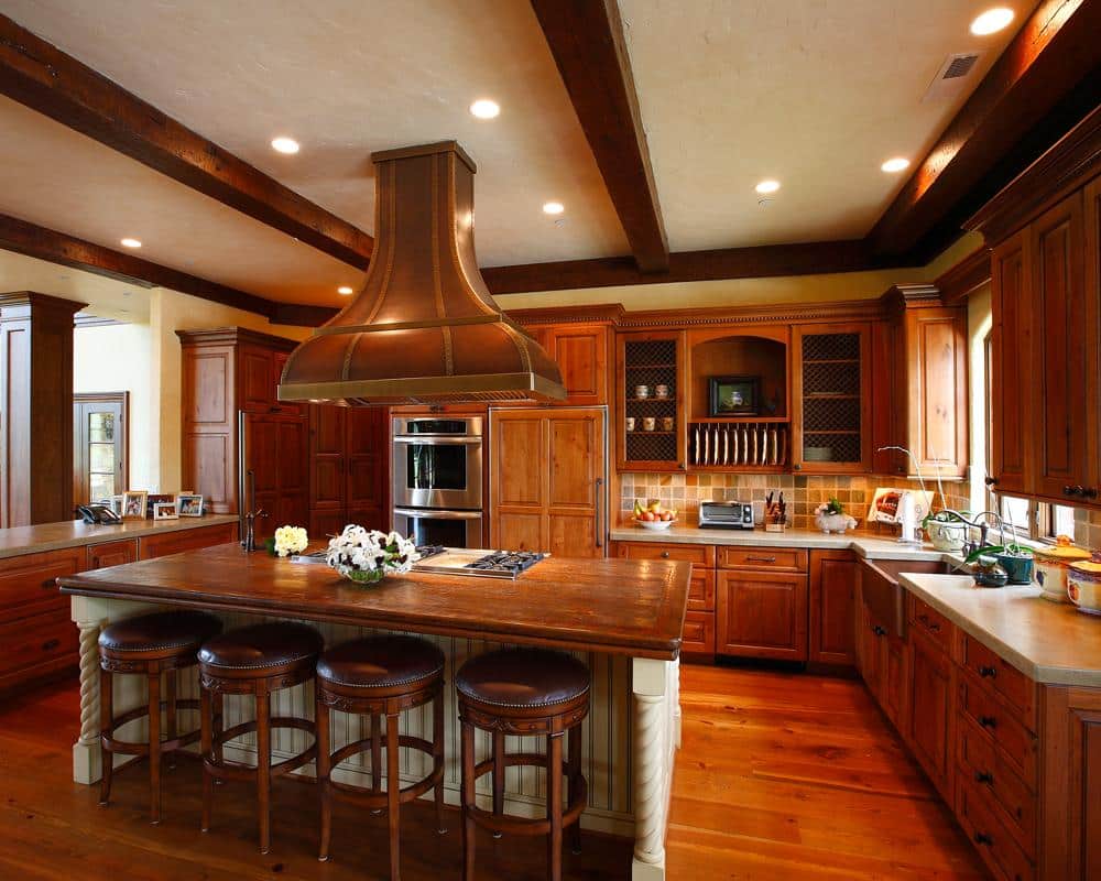 Traditional kitchen interior with rich wooden cabinetry, large island, and engineered wood elements for sustainable design in Canada