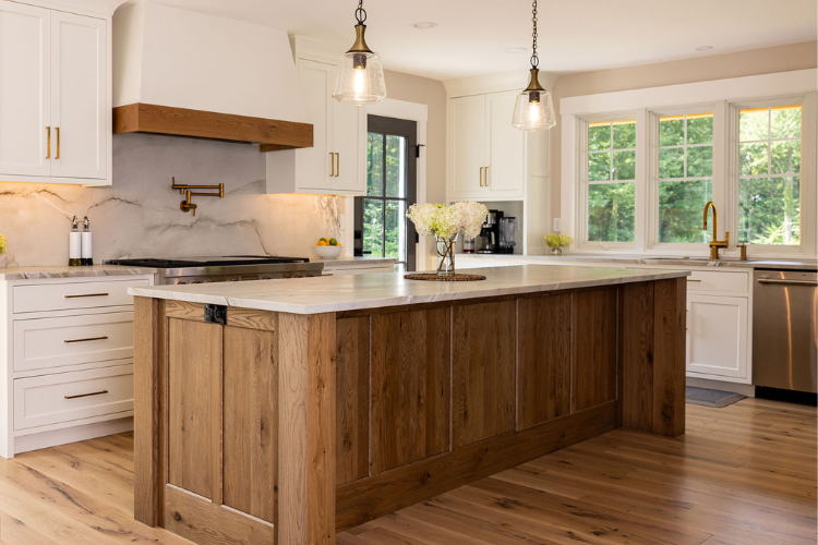 Kitchen Cabinets with white Shaker doors and rustic oak island, quartz countertop, brass hardware, bright natural light