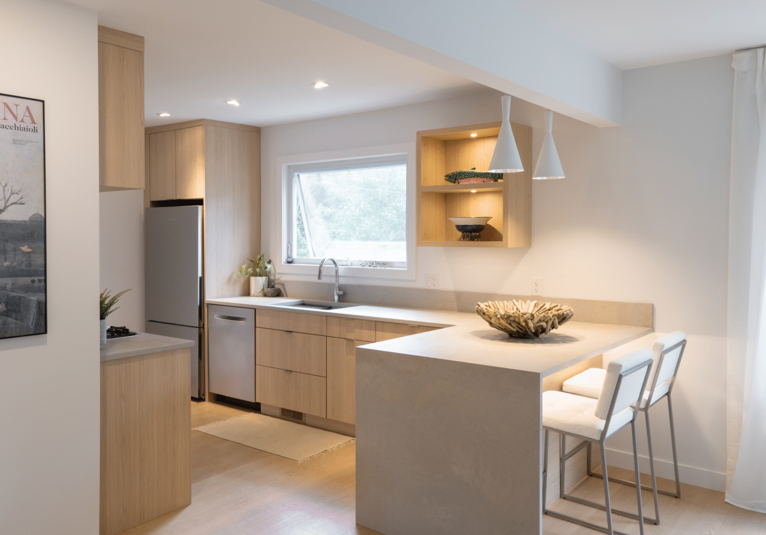Cabinet Design – minimalist kitchen with light wood flat-panel cabinets, integrated fridge, white countertops, and an open shelf display under pendant lights.