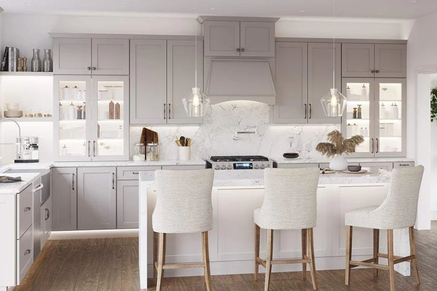 `DIY Trend with RTA Cabinets in Canada: bright modern kitchen with light gray shaker cabinets, marble island, and pendant lighting.`