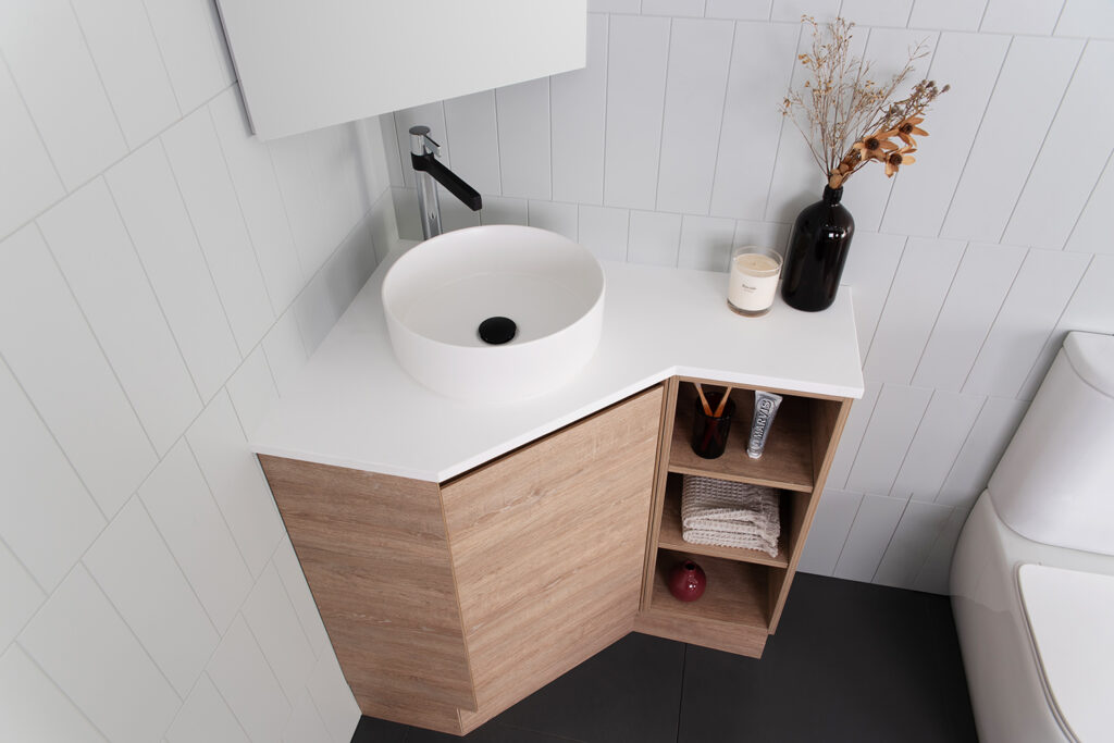 Corner bathroom vanity cabinet with integrated sink and open shelves for small bathrooms