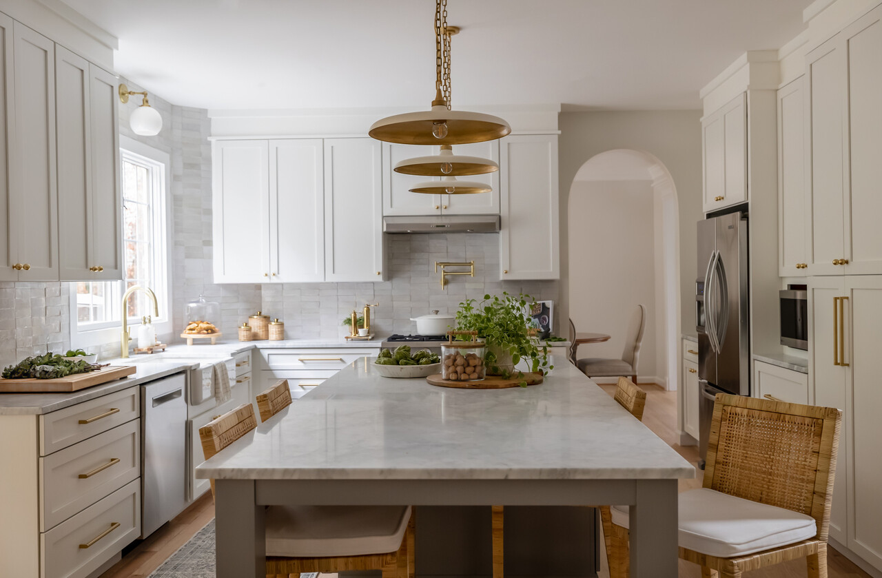White Shaker RTA cabinets and marble island in a bright modern farmhouse kitchen
