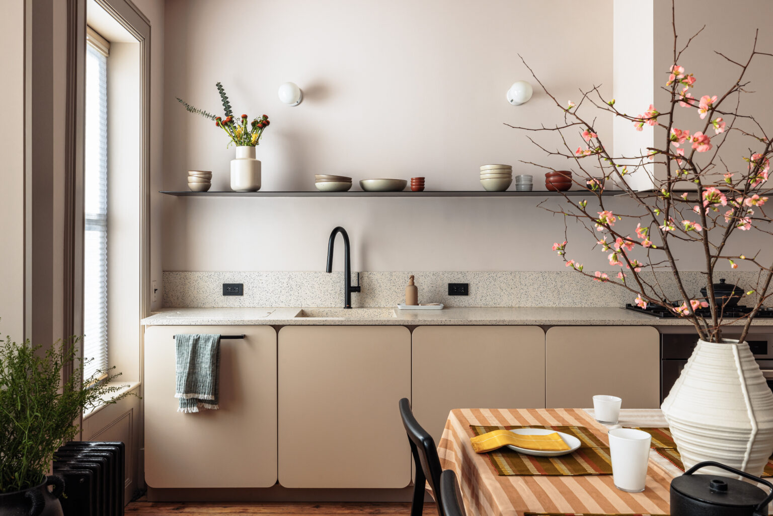 Minimalist Canadian kitchen featuring beige matte cabinets and terrazzo countertop — one of the best kitchen cabinet colors Canada homeowners love for a warm, modern, and organized look.