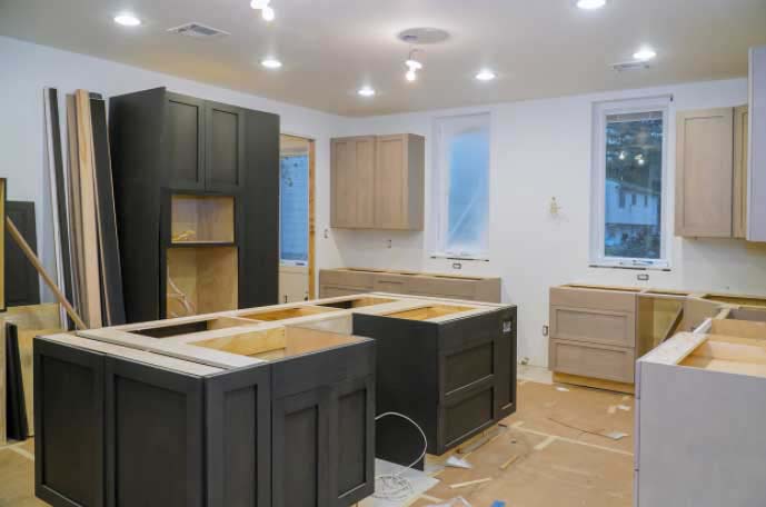 Installation process of premium RTA cabinets in Canada featuring two-tone plywood cabinetry with modern shaker design and precise craftsmanship.