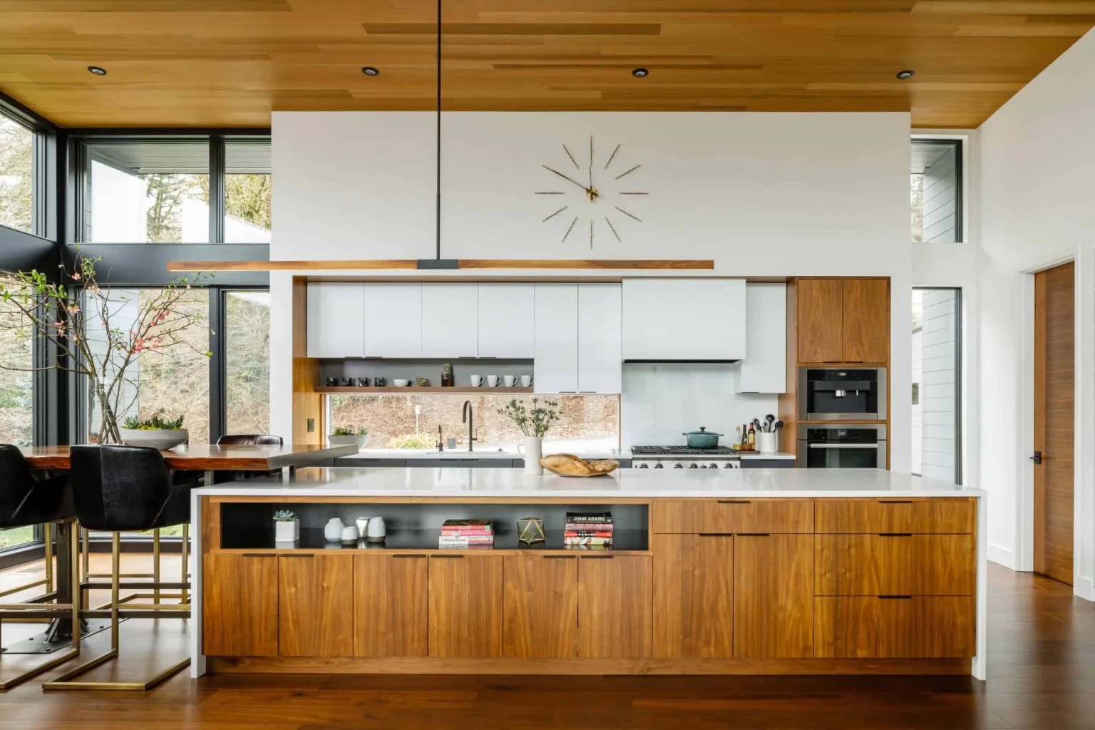 Contemporary kitchen featuring premium RTA cabinets Canada in walnut wood and white finishes, showcasing minimalist design, natural light, and modern elegance.
