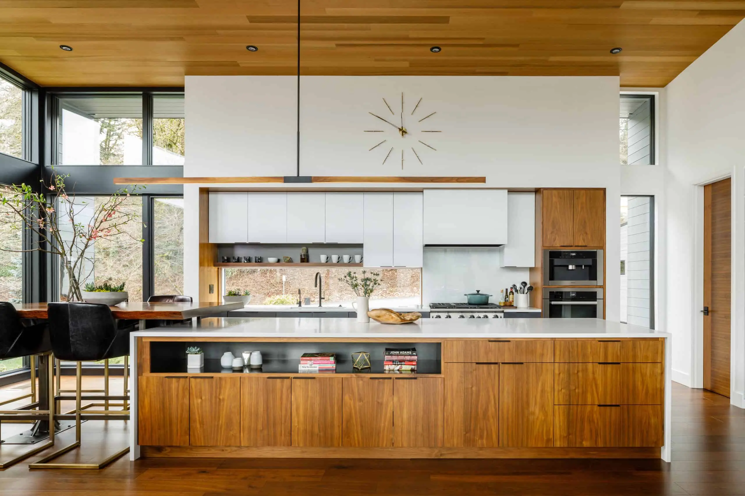 Contemporary kitchen featuring premium RTA cabinets Canada in walnut wood and white finishes, showcasing minimalist design, natural light, and modern elegance.