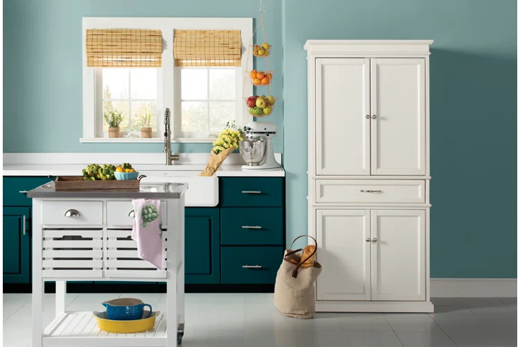 Modern Canadian kitchen featuring teal blue lower cabinets, crisp white upper storage cabinet, and a farmhouse sink — a stylish example of the best kitchen cabinet colors Canada 2025.