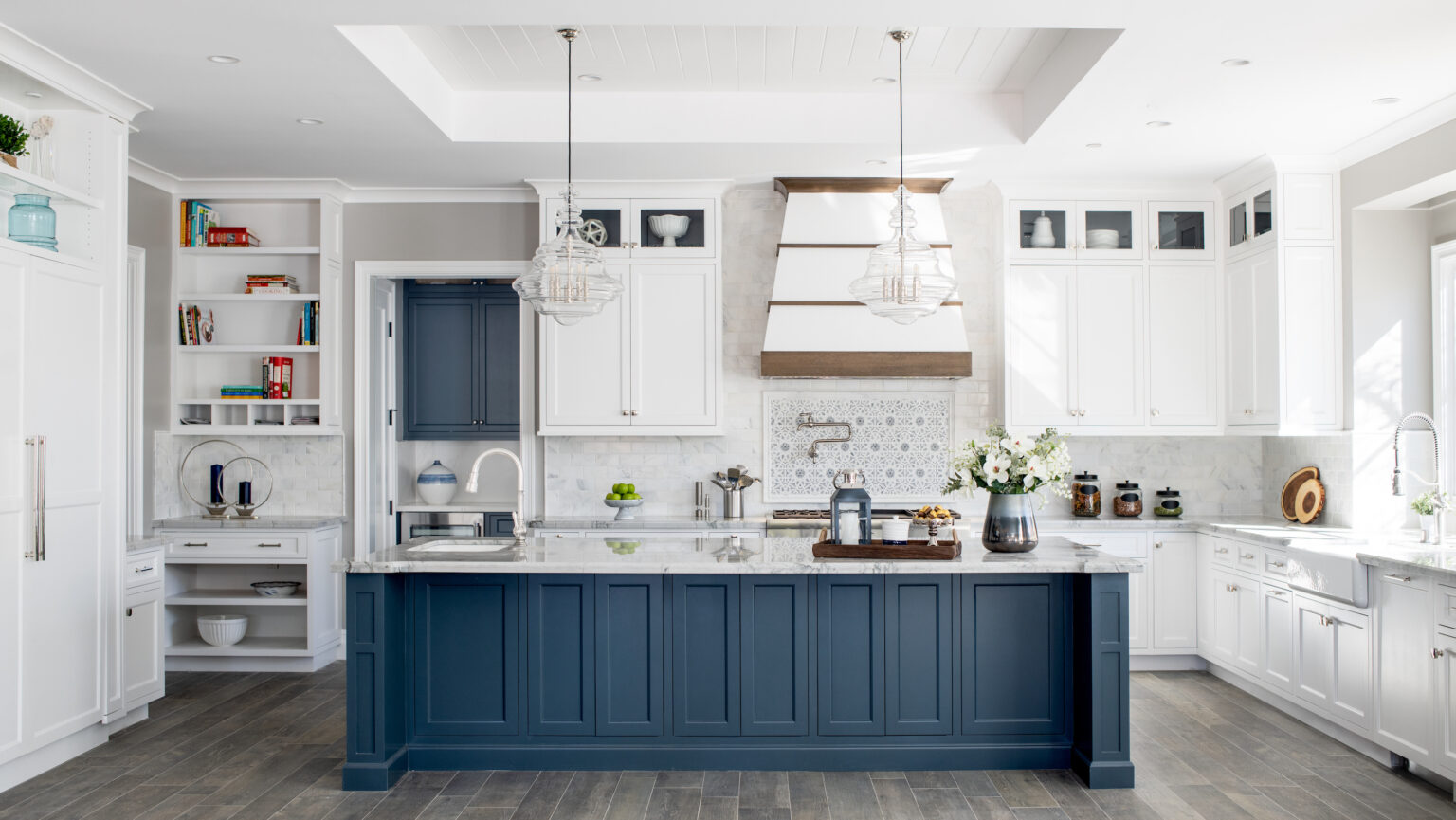 Elegant Canadian kitchen with white upper cabinets and navy blue island — showcasing one of the best kitchen cabinet colors Canada homeowners love for a timeless and coastal-inspired design.