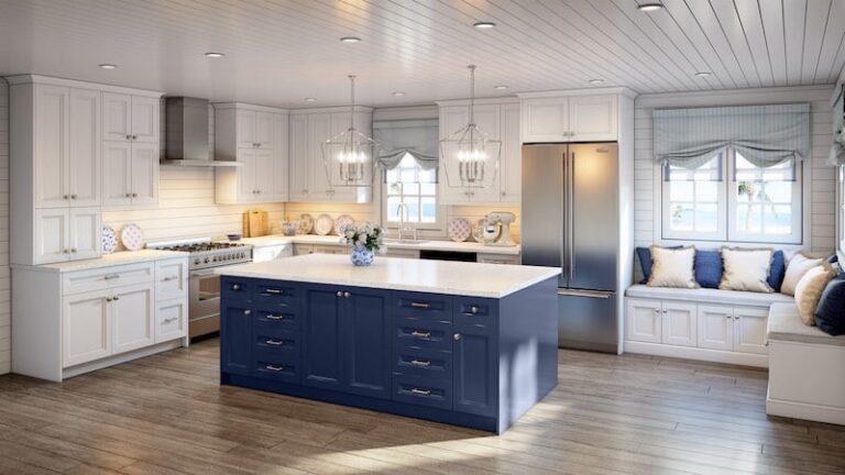 Coastal kitchen with white shaker RTA cabinets, navy island, quartz countertops, lantern pendants, stainless appliances, and a window-seat nook.