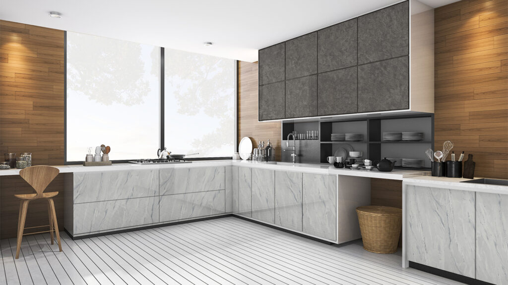 Minimalist L-shaped kitchen with sleek handleless kitchen cabinet design, featuring marble-look base units, dark grey upper cabinets, wood wall panels, and white plank flooring.