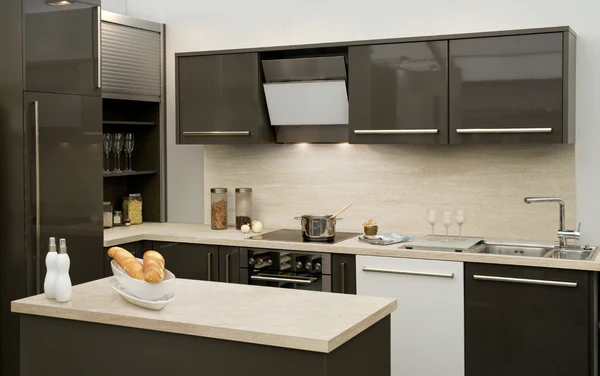 Compact modern kitchen with glossy dark brown kitchen cabinet fronts, beige countertops, and built-in appliances.