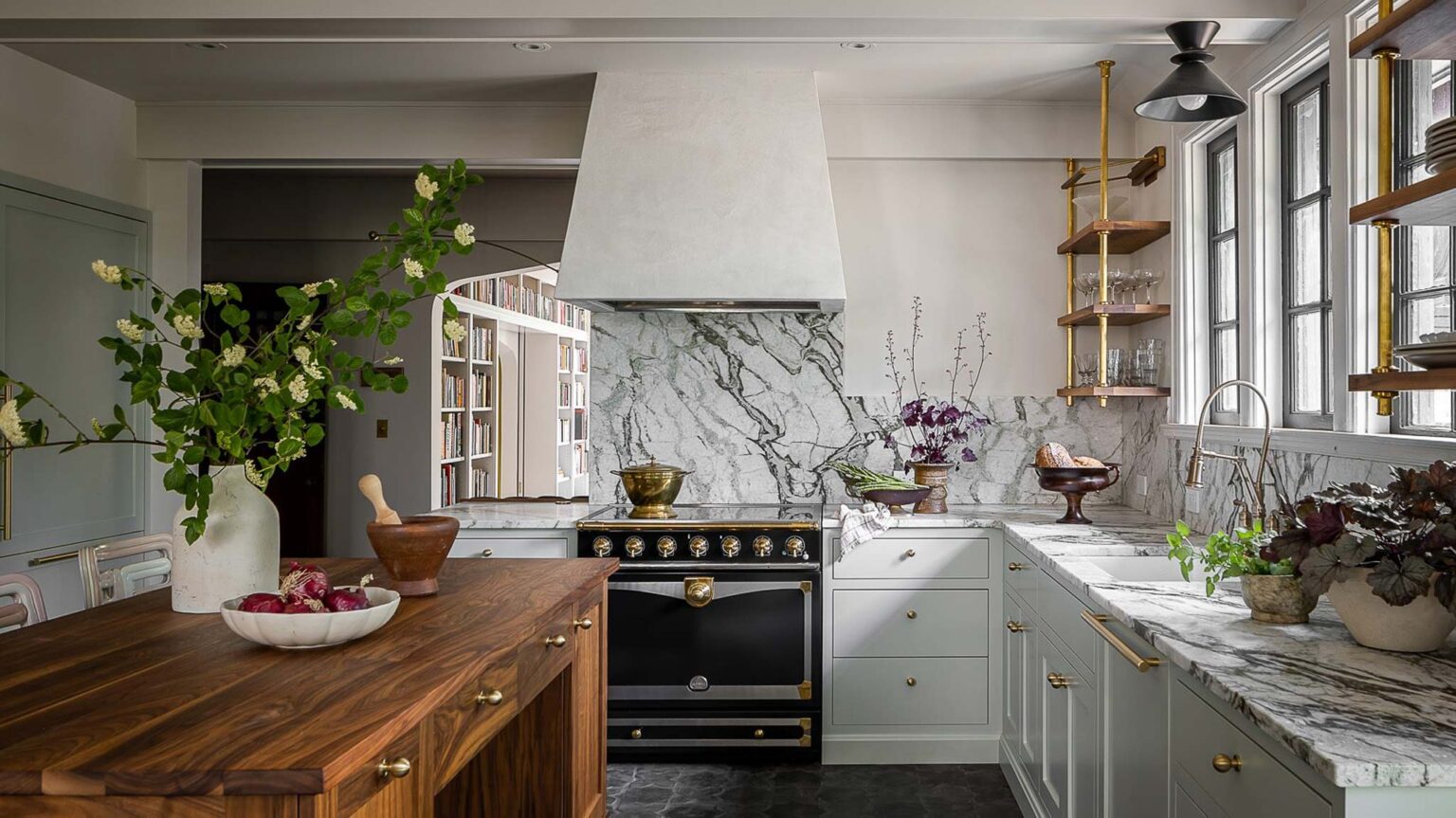 Modern kitchen with sage-gray shaker cabinets, brass hardware, and dramatic marble backsplash—low price kitchen cabinet inspiration with a high-end look.