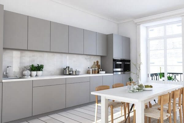 Minimalist modern kitchen with matte grey flat pack kitchen cabinet units, handleless doors, and a bright dining area by the window.