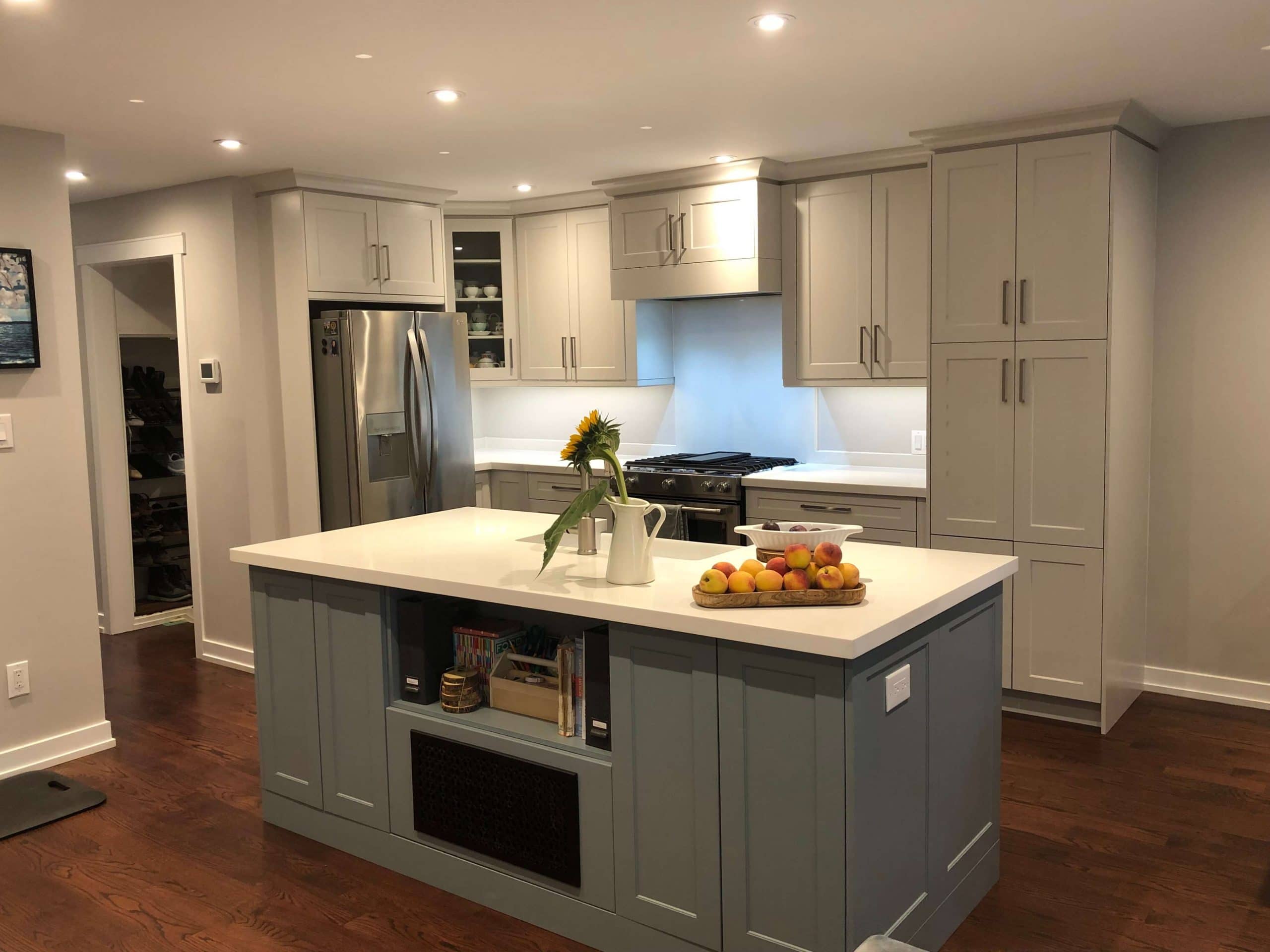 Modern shaker-style Kitchen Cabinet Mississauga design with grey cabinetry, a white quartz island, stainless steel appliances, and recessed ceiling lighting.
