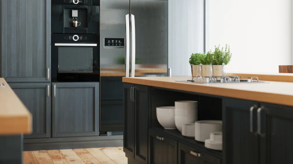 Low price kitchen cabinet inspiration in a modern kitchen with dark shaker cabinets, a wood countertop island, and built-in stainless appliances.