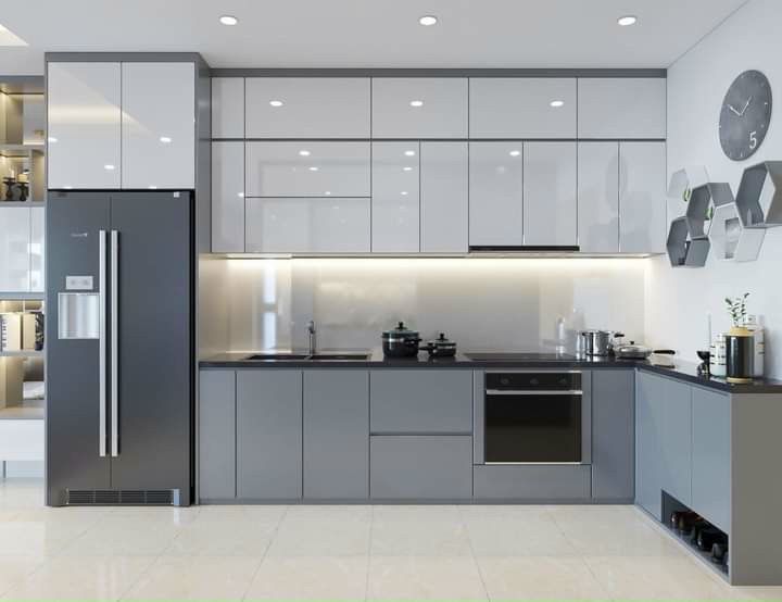 Modern L-shaped kitchen featuring two-tone white and grey Kitchen Cabinet Mississauga units with floor-to-ceiling vertical storage and integrated appliances