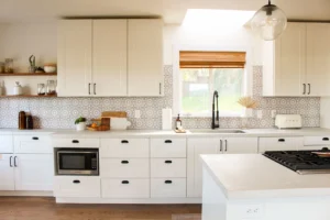 Flat pack kitchen cabinet in a modern Canadian kitchen featuring white shaker cabinets, soft-close drawers, quartz countertops, and a functional island layout