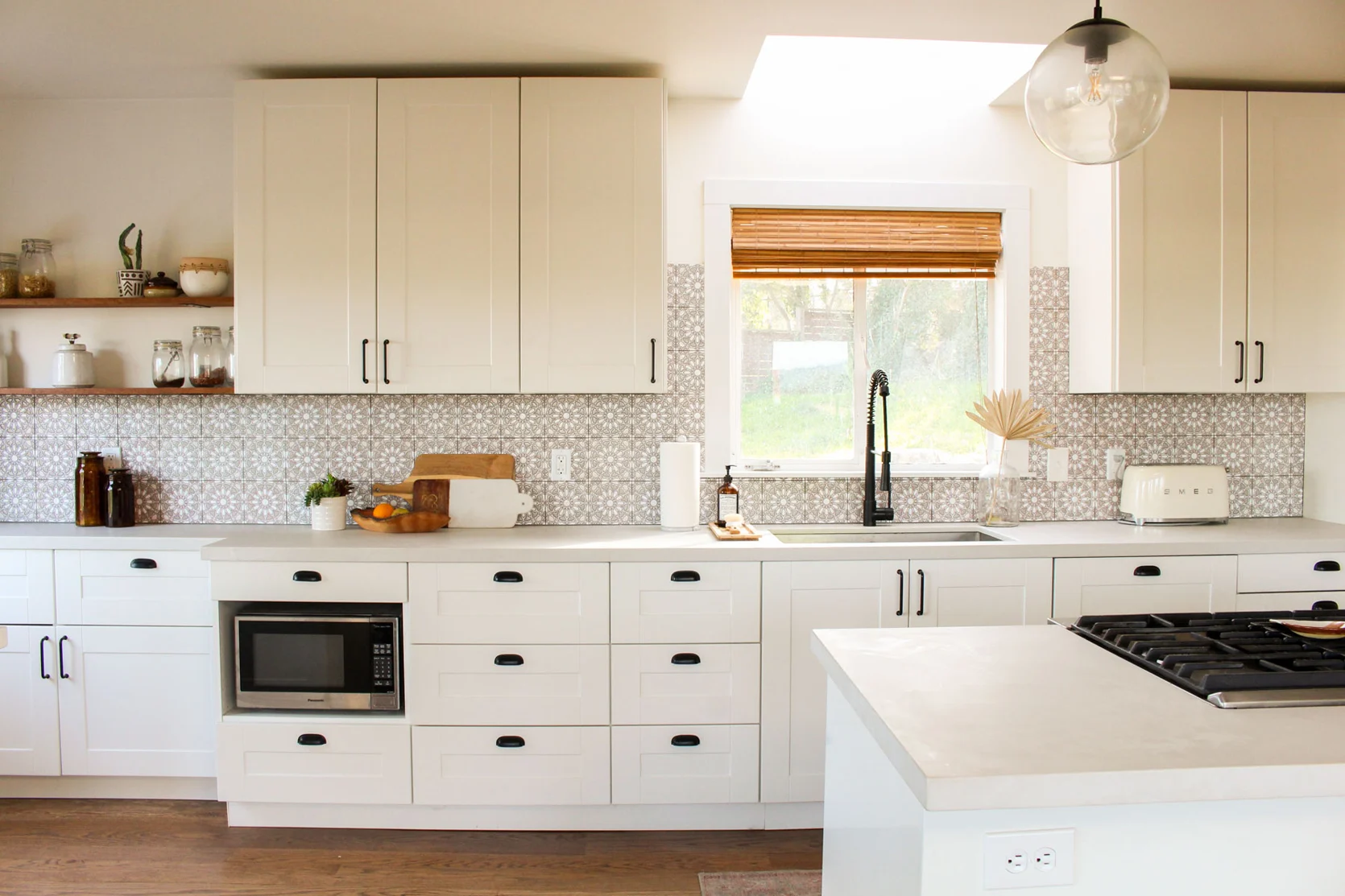 Flat pack kitchen cabinet in a modern Canadian kitchen featuring white shaker cabinets, soft-close drawers, quartz countertops, and a functional island layout