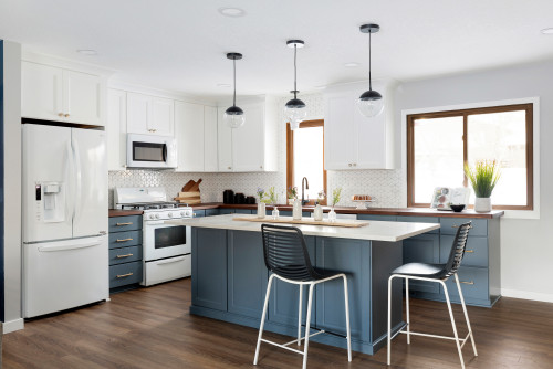 Modern Kitchen cabinet Mississauga design featuring white upper cabinets, a blue kitchen island, soft-close drawers, and a bright open-concept layout in a Canadian home.