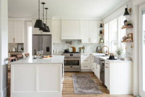 Modern white kitchen cabinet Mississauga design with shaker-style cabinets, large island, stainless steel appliances, and bright natural light