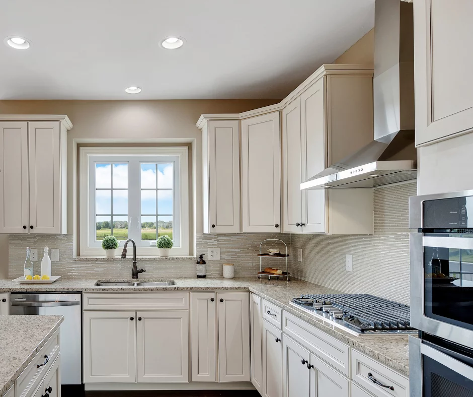 White shaker RTA kitchen cabinets with glass uppers, crown molding, and classic traditional design
