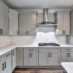 Modern grey shaker RTA kitchen cabinets Ontario with white quartz countertops and stainless range hood