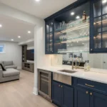 Navy blue shaker cabinets with glass-front uppers and quartz counter—storage inspiration for Bathroom Cabinets.