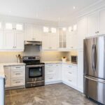 Modern kitchen cabinet Mississauga design with grey shaker cabinets, quartz island, and brass pendant lighting