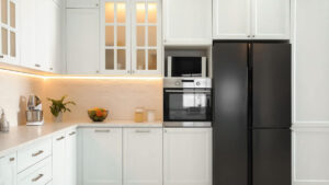 Low price kitchen cabinets in a bright modern white kitchen with a large island and quartz countertop