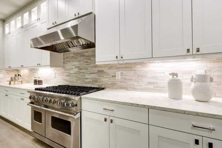 Low price kitchen cabinets in Ontario featuring modern white shaker RTA cabinets and under-cabinet lighting