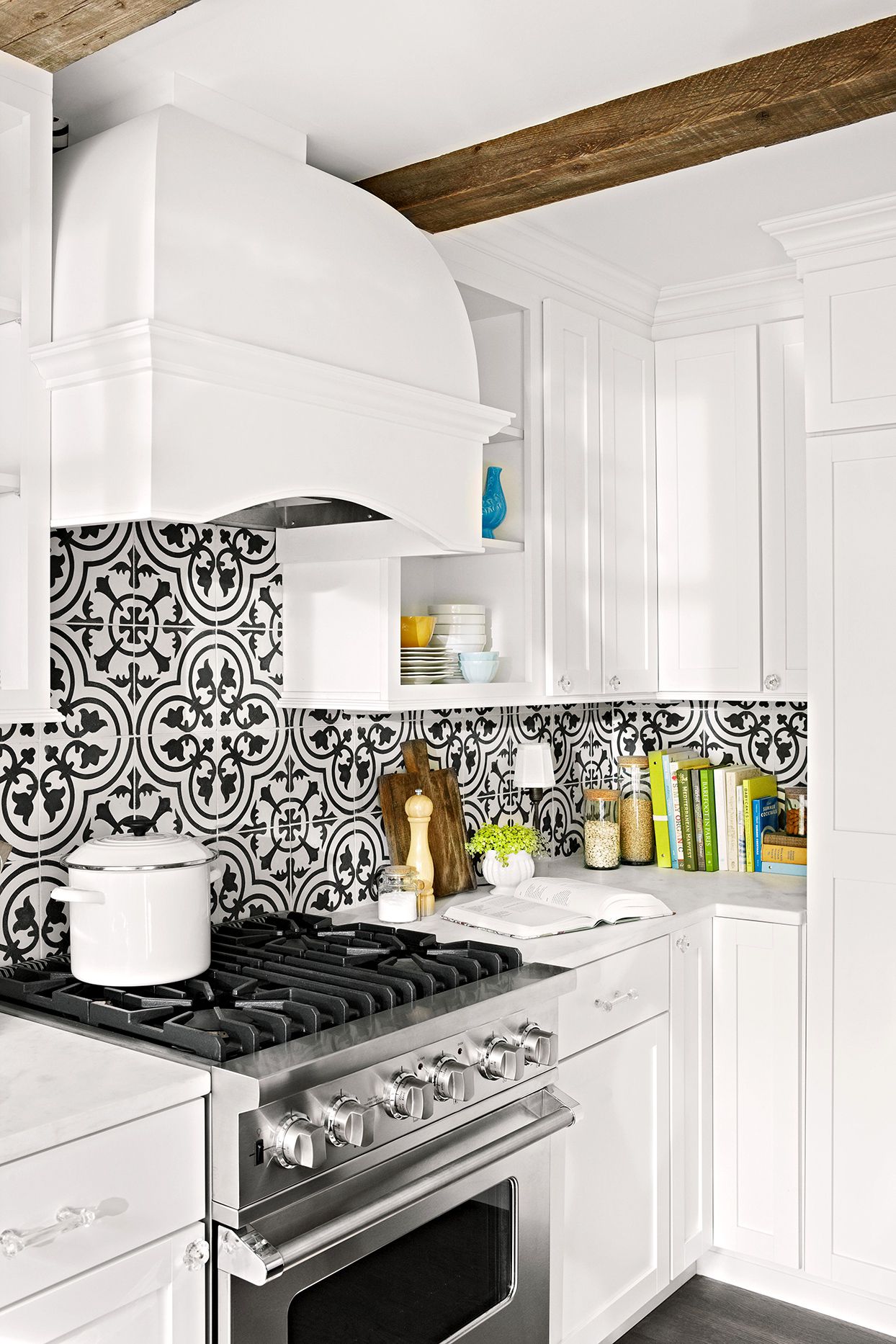 Low price kitchen cabinet design in a bright white traditional U-shaped kitchen with a small island