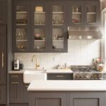 Modern dark gray shaker-style low price kitchen cabinets with brass hardware and white countertop