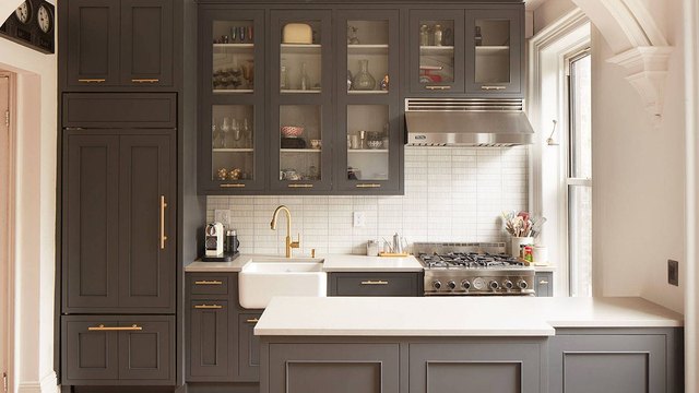 Modern dark gray shaker-style low price kitchen cabinets with brass hardware and white countertop