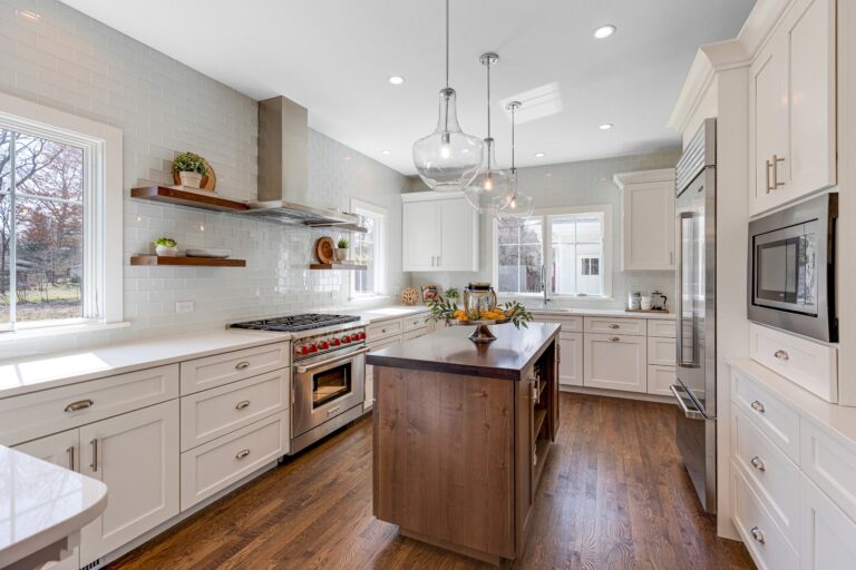 Low price kitchen cabinets in Ontario in a bright white shaker kitchen with island and stainless appliances