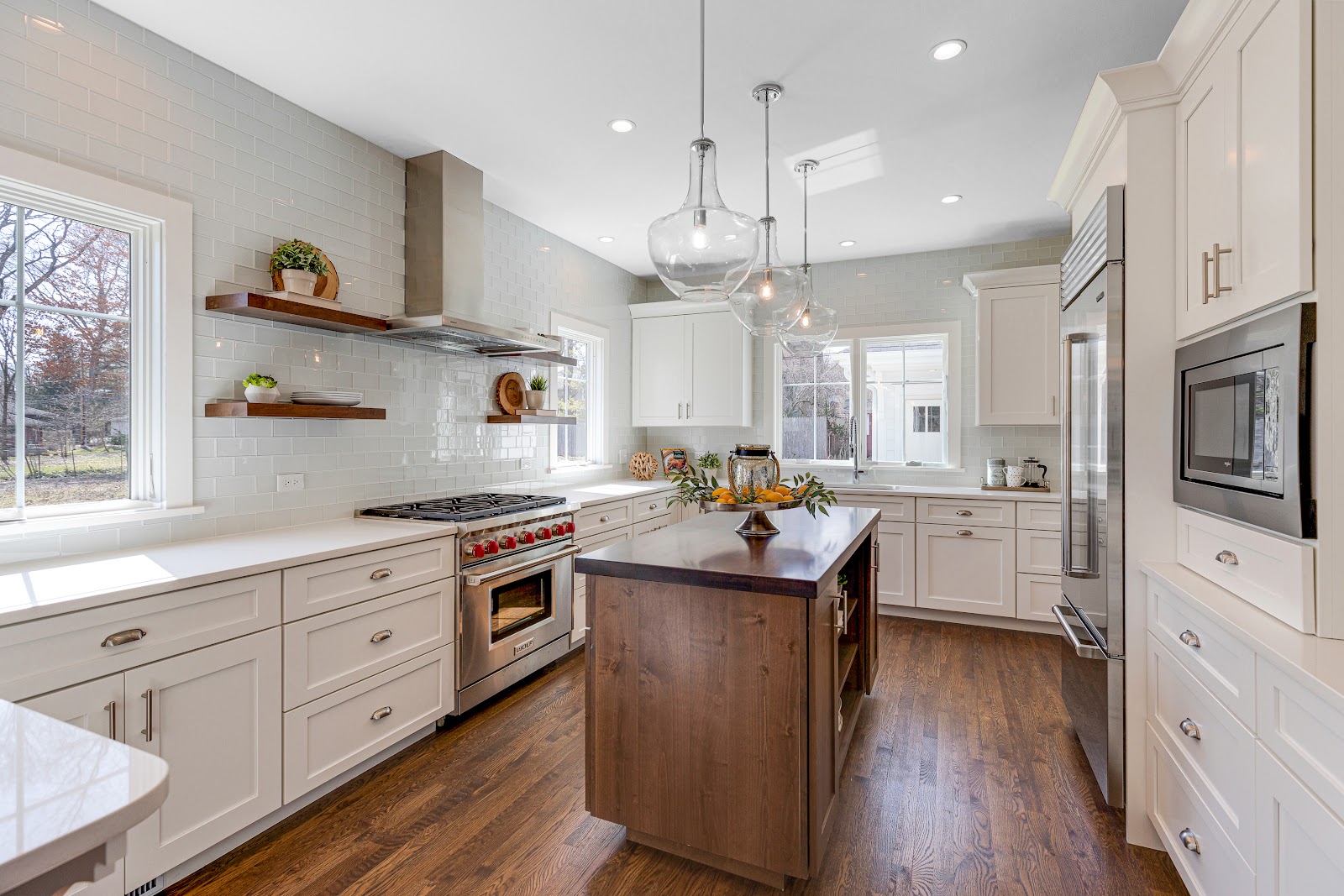 Low price kitchen cabinets in Ontario in a bright white shaker kitchen with island and stainless appliances