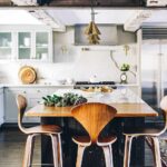 Modern farmhouse kitchen with gray shaker cabinets, marble island, and stainless steel fridge from trusted KITCHEN SUPPLIERS.