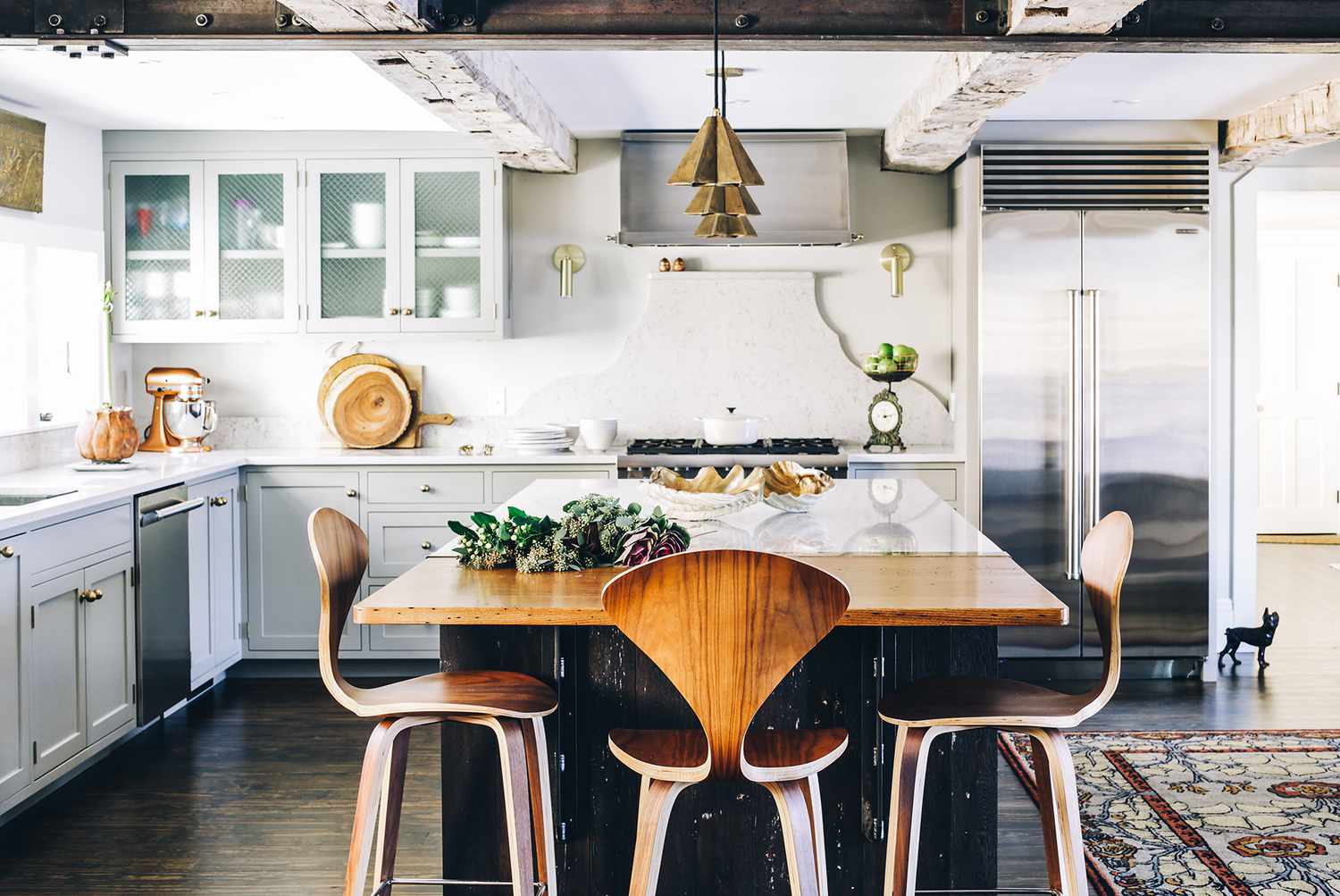 Modern farmhouse kitchen with gray shaker cabinets, marble island, and stainless steel fridge from trusted KITCHEN SUPPLIERS.