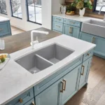 Premium kitchen cabinets in a modern gray shaker kitchen with stainless steel appliances and quartz countertops