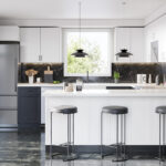 Modern two-tone kitchen cabinets in Mississauga featuring white shaker uppers, a bright island, and a dark marble backsplash.