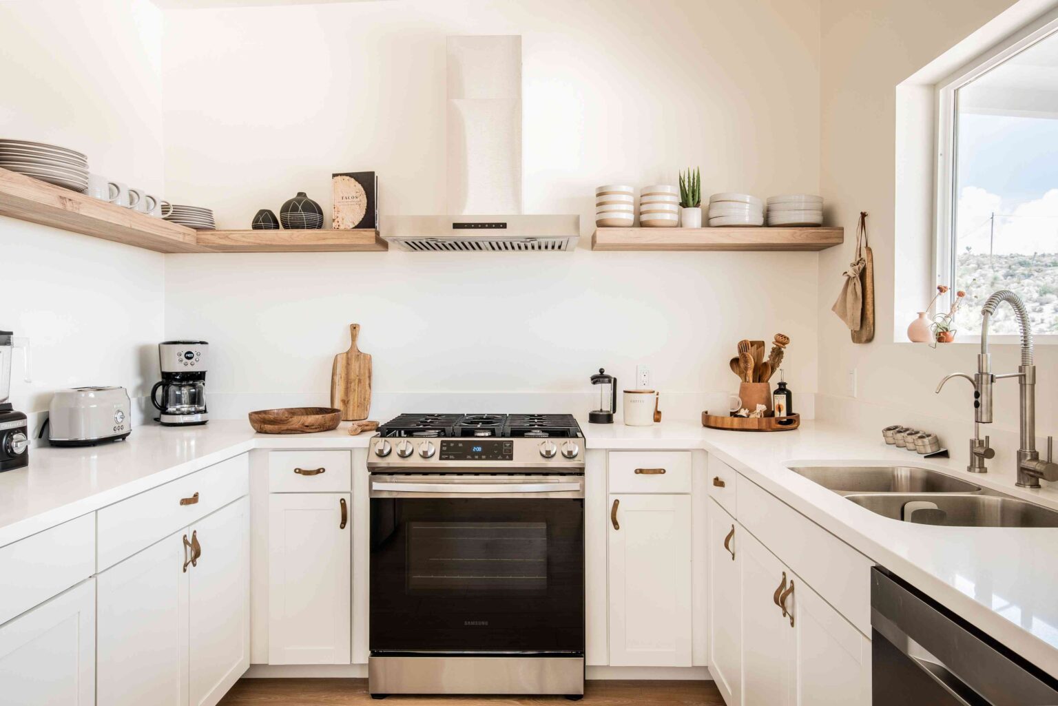 Bright U-shaped kitchen with white IKEA kitchen cabinets for small kitchens and open wood shelves