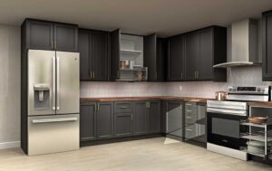L-shaped kitchen with dark shaker IKEA kitchen cabinets, brass pulls, wood countertops, and stainless steel appliances.